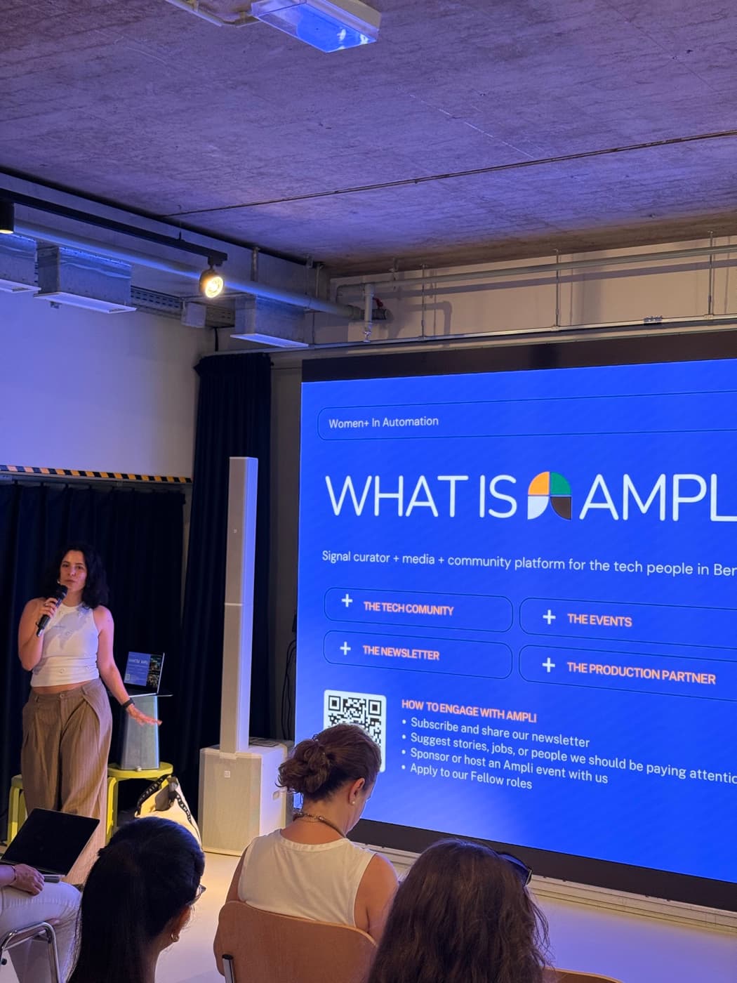 Speaker presenting "What is Ampli" at a community event